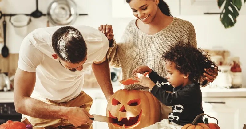 A family carving pumpkins for Halloween.
