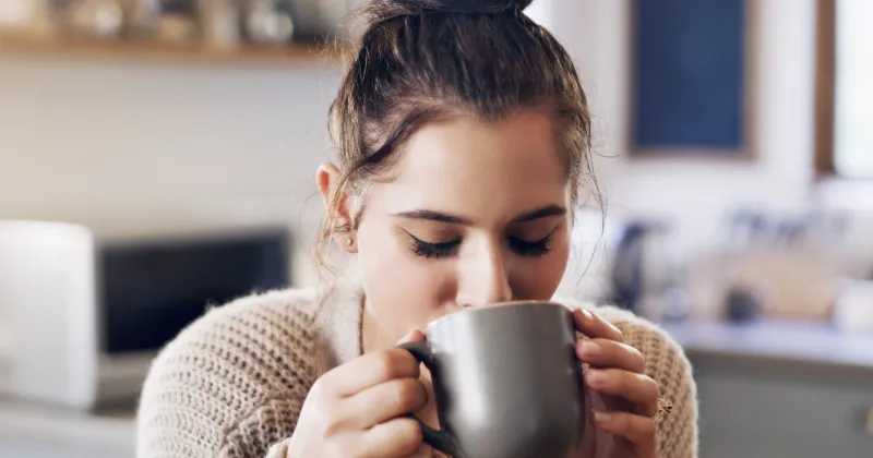 girl sipping a cup of coffee