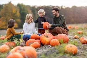 Family enjoying a pumpkin patch