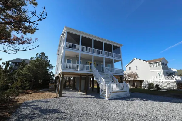 This tall 2 Story Beracah just outside of Broadkill Beach, Delaware overlooks the Bay on the front and Prime Hook off this deck.