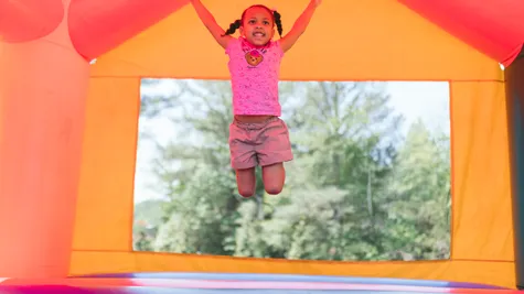 kid jumping in a bouncy house