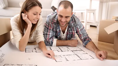 couple looking at the floor plan of their new home