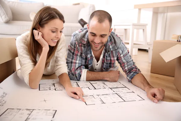 couple looking at the floor plan of their new home