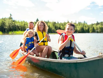 family kayaking on the lake