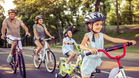 family riding bikes in the blair estates neighborhood