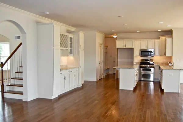 White Kitchen with Oak Hardwood Flooring
