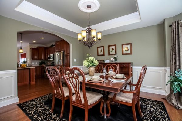 Elegant Dining Room with Tray Ceiling, Crown Moulding and Wainscoting
