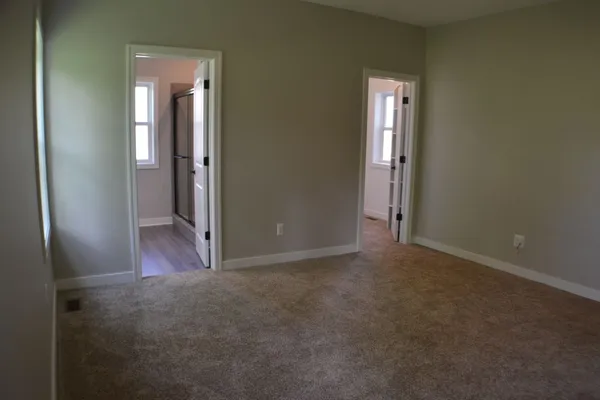 Master Suite with doors to full bath and large closet