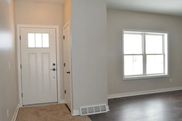 Front Door w/ Coat Closet / Living Room