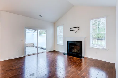 Great room fire place hardwood floors looking out to private courtyard