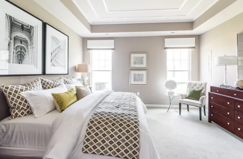 Owner's suite model home carpet flooring king size bed natural light
