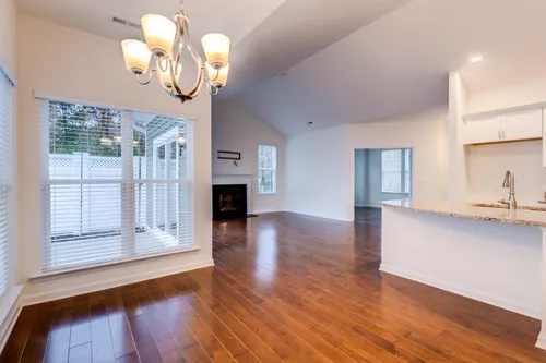 Great Room and kitchen colonnade hardwood floors fire place