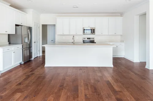 The Amelia Kitchen White Cabinets Hardwood Floor kitchen island Cornerstone Homes