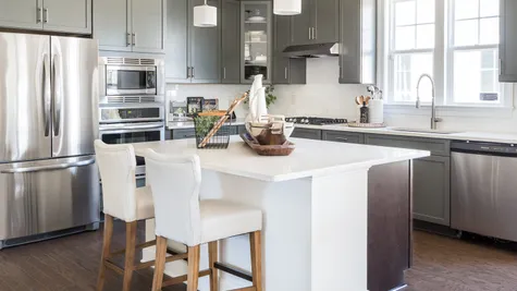 Gray kitchen with stainless appliances by Cornerstone Homes