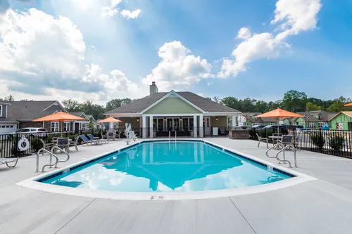 Ashlake Pool and Rear Exterior Clubhouse seating umbrellas resort style amenities