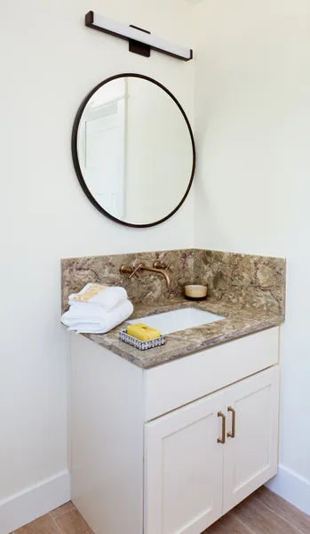 Bathroom vanity with quartz countertops.