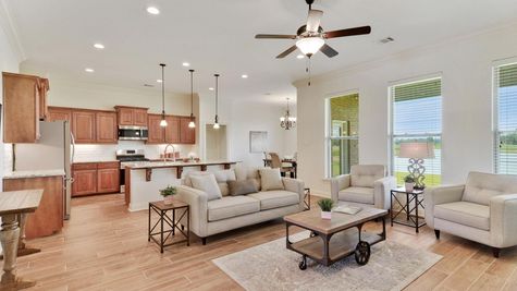 The Reserve at Conway Model Home Pictures- Large living room area with wood look floors