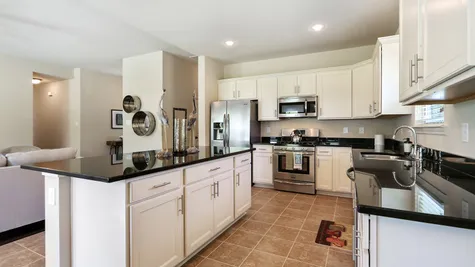 Natural Light- White Cabinets - Dark Granite- Living Room- Kitchen- Open Floor Plan- Model Home- Silver Hill- Community- Ponchatoula Louisiana- Hammond area- DSLD Homes