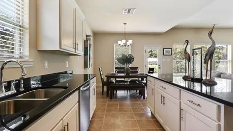 Natural Light- White Cabinets - Dark Granite- dining area- Kitchen- Open Floor Plan- Model Home- Silver Hill- Community- Ponchatoula Louisiana- Hammond area- DSLD Homes