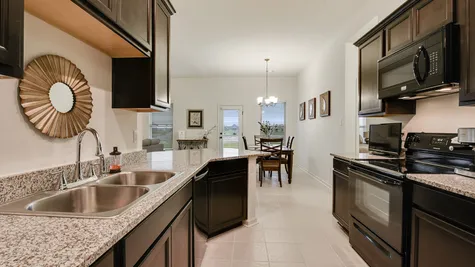 Kitchen with Dark Brown Cabinets  - Summerview - DSLD Homes Lafayette