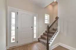 Foyer with carpet stairs and open oak handrail with iron balusters - *customer selections*