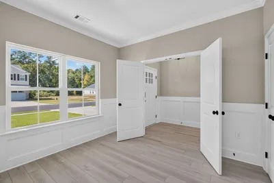 Interior view of the first-floor den in at 186 Hanover Place, looking toward the entryway with natural light from large front-facing windows.
