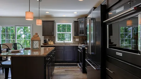 Kitchen with dark brown cabinets in the Ambrook model from Garman Builders