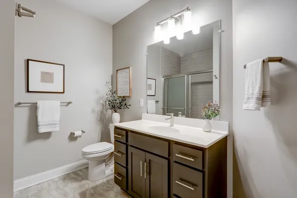 Remodeled full bathroom with sliding door shower from Garman Builders