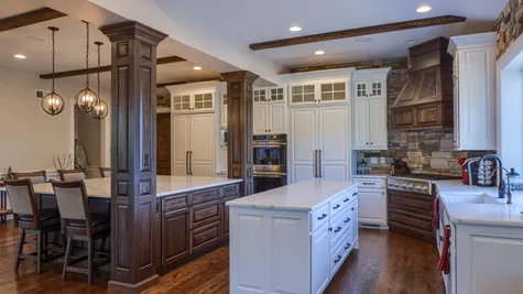 Kitchen with white cabinets a center island in a remodeled home from Garman builders