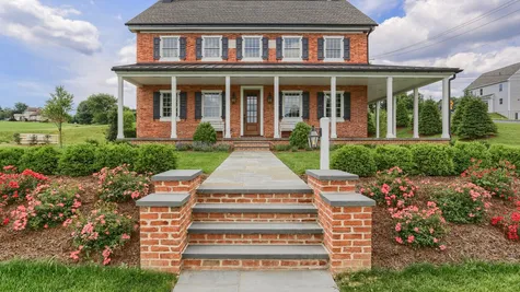 Front of a remodeled Brick home with white accents from Garman Builders