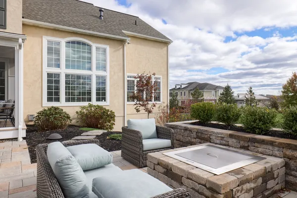 Outdoor patio with a stone fire pit and couches from Garman builders