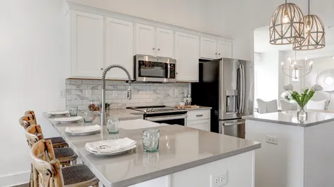 Kitchen with white cabinets and center island in the Archer model from Garman Builders