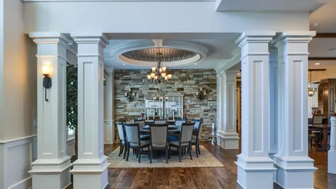 Dining room with a stone wall in a remodeled home from Garman builders