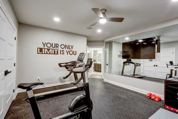 Remodeled gym area with a tv on the wall from Garman Builders