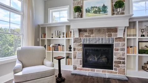 Stone fireplace in the living room in the Abigail Model from Garman Builders