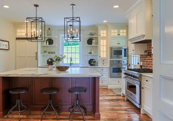 Kitchen with white cabinets and a center island in a Garman Builders remodel