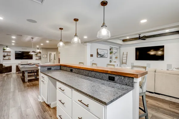 Remodeled kitchen with a center island and white cabinets from Garman Builders