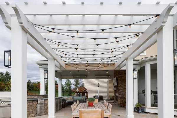 Outdoor patio with a pergola and a table with seating from Garman builders