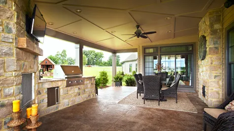Outdoor patio with seating and grill from Garman Builders