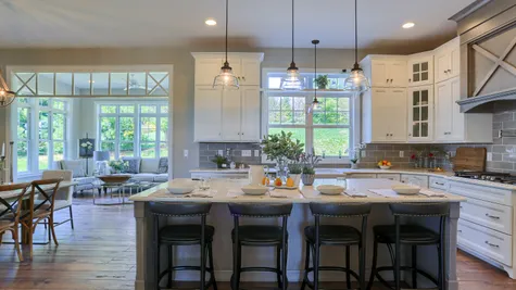 Kitchen with white cabinets and center island in the Abigail Model from Garman Builders