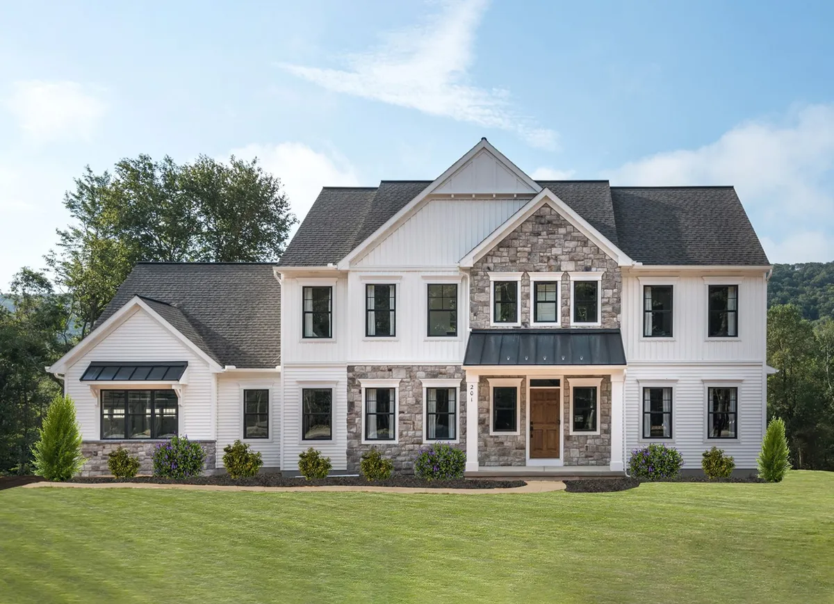 Front elevation of a white home with stone accents from Garman Builders