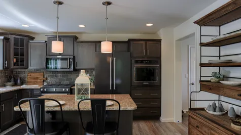Kitchen with dark brown cabinets in the Ambrook model from Garman Builders