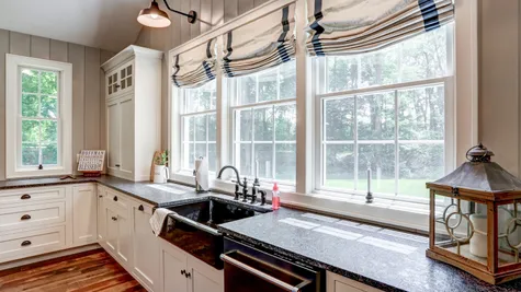 Kitchen with white cabinets in a remodeled home from Garman builders