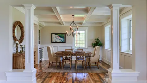 Dining room with a chandelier in a remodeled home from Garman builders