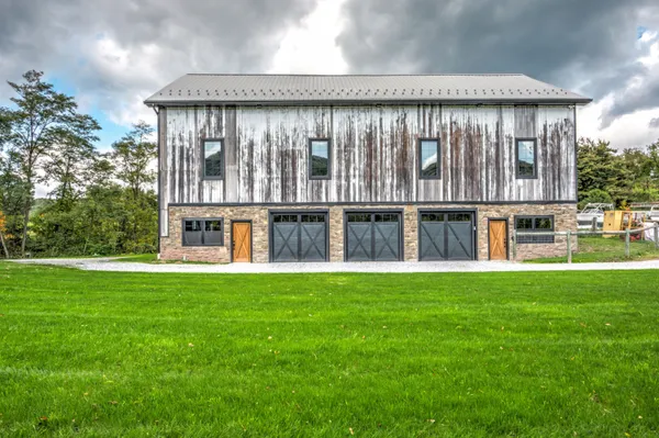 Exterior of a renovated barn with a 3 car garage