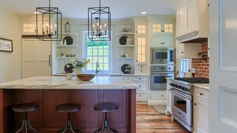 Remodeled Kitchen with white cabinets and center island from Garman Builders