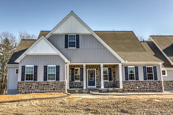 Front elevation of a Gray home with stone accents from Garman Builders