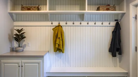 Mudroom with built in shelves in a remodeled home from Garman builders