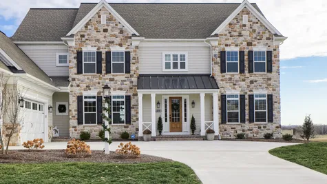 Front elevation of a stone house from Garman Builders