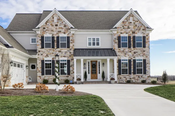 Front elevation of a stone house from Garman Builders